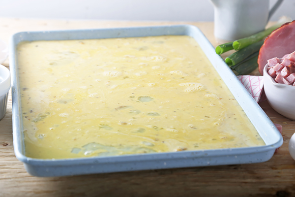 Seasoned egg mixture poured onto a sheet pan before baking
